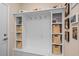 Mudroom with shelving, storage, and hooks is located just inside the garage entry door at 9169 Nw Oldfield Rd., Calabash, NC 28467