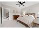 Comfortable bedroom with soft carpet, ceiling fan, and convenient access to the staircase at 93 Knotty Pine Way, Murrells Inlet, SC 29576