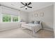 Bright bedroom boasts a vanity, large window, ceiling fan, and soft carpet for added comfort at 93 Knotty Pine Way, Murrells Inlet, SC 29576