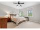 Cozy bedroom with neutral decor, a ceiling fan, two large windows, and a quaint desk space at 93 Knotty Pine Way, Murrells Inlet, SC 29576