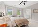 Cozy bedroom features soft carpet, two windows, ceiling fan, and an ensuite bathroom for added convenience at 93 Knotty Pine Way, Murrells Inlet, SC 29576