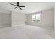 Spacious bedroom offers soft carpet, neutral walls, ceiling fan, and natural light at 93 Knotty Pine Way, Murrells Inlet, SC 29576
