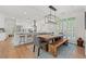Open dining area with rustic wood table, bench, and modern lighting at 93 Knotty Pine Way, Murrells Inlet, SC 29576