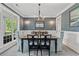 Traditional dining room featuring a chandelier, elegant wallpaper, wainscoting, and a large window at 93 Knotty Pine Way, Murrells Inlet, SC 29576