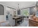 Dining room with detailed trim, a large window, elegant decor, and an open view to the living space at 93 Knotty Pine Way, Murrells Inlet, SC 29576