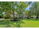 Charming two-story home with inviting front porch, columns and landscaped yard with mature trees at 93 Knotty Pine Way, Murrells Inlet, SC 29576