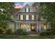 Charming two-story home with inviting front porch, columns and landscaped yard at dusk at 93 Knotty Pine Way, Murrells Inlet, SC 29576
