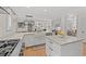 Open concept kitchen with white cabinets, large island, stainless steel appliances, and breakfast bar at 93 Knotty Pine Way, Murrells Inlet, SC 29576