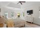 Bright and airy main bedroom with tray ceiling, large windows, comfortable furniture, and a ceiling fan at 93 Knotty Pine Way, Murrells Inlet, SC 29576