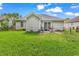 Backyard featuring green grass, and the rear of a single story home with grey siding at 9450 Leeds Circle, Myrtle Beach, SC 29588