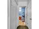 Hallway view to bathroom, which includes single vanity, mirror and a stand for additional storage at 9450 Leeds Circle, Myrtle Beach, SC 29588