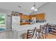 Well-equipped kitchen with white countertops, wooden cabinets, and a breakfast bar at 9450 Leeds Circle, Myrtle Beach, SC 29588