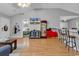 Open living space showcasing laminate flooring, kitchen bar access and view into adjacent bedroom at 9450 Leeds Circle, Myrtle Beach, SC 29588