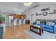 Spacious open-concept living area with laminate flooring, a vaulted ceiling, and a breakfast bar connecting to the kitchen at 9450 Leeds Circle, Myrtle Beach, SC 29588