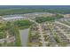 Aerial view of a community with houses, ponds, and green spaces at 100 Oak Leaf Dr., Longs, SC 29568