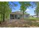 View of the house with screened porch, grey siding, backyard and blue sky at 100 Oak Leaf Dr., Longs, SC 29568