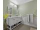 Bright bathroom featuring double sinks, a neutral color scheme, and modern fixtures at 100 Oak Leaf Dr., Longs, SC 29568