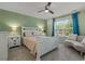 Cozy bedroom with a white bed frame, ceiling fan, and a window providing natural light at 100 Oak Leaf Dr., Longs, SC 29568