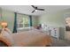 Inviting bedroom with a white bed, ceiling fan, and a view of the outdoors at 100 Oak Leaf Dr., Longs, SC 29568