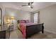 Comfortable bedroom with a colorful bedspread, dark furniture, and a window with curtains at 100 Oak Leaf Dr., Longs, SC 29568