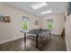 Bright game room featuring a ping pong table, wood floors, and large windows at 100 Oak Leaf Dr., Longs, SC 29568