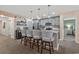 Kitchen island with bar stool seating with quartz countertops, stainless steel appliances and wood shelving at 100 Oak Leaf Dr., Longs, SC 29568