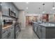 Modern kitchen with stainless steel appliances, island, and open view into the dining area at 100 Oak Leaf Dr., Longs, SC 29568