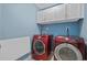Laundry room featuring a red front-load washer and dryer with white cabinets at 100 Oak Leaf Dr., Longs, SC 29568