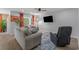 Comfortable living room with neutral tones, plush seating, and an entertainment center at 100 Oak Leaf Dr., Longs, SC 29568