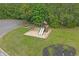 Community playground with slides, swings, and a sand area, surrounded by lush greenery at 100 Oak Leaf Dr., Longs, SC 29568
