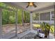 Relaxing screened porch with ceiling fan and view of the backyard at 100 Oak Leaf Dr., Longs, SC 29568