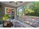 Inviting screened porch with comfortable seating and backyard view at 100 Oak Leaf Dr., Longs, SC 29568