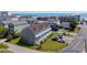 A coastal townhome complex is situated along a street with ocean views, parking, and manicured landscaping at 112 3Rd Ave. S # B, Surfside Beach, SC 29575