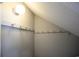 An attic storage space with multiple hooks on the walls with a textured ceiling and a single light overhead at 112 3Rd Ave. S # B, Surfside Beach, SC 29575