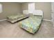 Bright bedroom featuring two twin beds with tropical patterned bedding and a window at 112 3Rd Ave. S # B, Surfside Beach, SC 29575