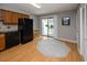 Open concept kitchen with black appliances, wood cabinets, and a sliding glass door at 112 3Rd Ave. S # B, Surfside Beach, SC 29575