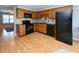 The kitchen has wood cabinets, black appliances, and a tan floor at 112 3Rd Ave. S # B, Surfside Beach, SC 29575