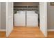 A laundry room features a modern white washer and dryer with shelves in an organized closet space at 112 3Rd Ave. S # B, Surfside Beach, SC 29575