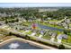 Wide aerial view of the neighborhood featuring a pond and manicured lawns and landscaping at 1133 6Th Ave. S, North Myrtle Beach, SC 29582