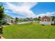 Beautiful backyard featuring a pool, green grass, a storage shed and views of the pond and neighboring homes at 1133 6Th Ave. S, North Myrtle Beach, SC 29582