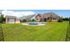 Backyard featuring a pool, green grass, and the rear exterior of the home with neutral siding and white trim at 1133 6Th Ave. S, North Myrtle Beach, SC 29582