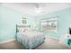 Cozy bedroom features a metal frame bed, ceiling fan, and a window view of the backyard at 1133 6Th Ave. S, North Myrtle Beach, SC 29582