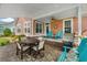 Covered patio with a grill, dining set, and rocking chairs, set on a brick paver surface at 1133 6Th Ave. S, North Myrtle Beach, SC 29582