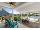 Inviting covered patio with outdoor seating, grill, and a view of the sparkling swimming pool at 1133 6Th Ave. S, North Myrtle Beach, SC 29582