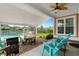 Outdoor patio features a grill, table, and chairs, overlooking the pool and waterway, perfect for entertaining at 1133 6Th Ave. S, North Myrtle Beach, SC 29582