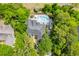 Aerial view of a beautiful home surrounded by trees with pool, patio, and backyard at 1203 Crooked Oak Dr., Pawleys Island, SC 29585