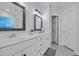 Bright bathroom featuring double sinks with mirrors, white cabinets, and tiled floors at 1203 Crooked Oak Dr., Pawleys Island, SC 29585
