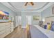 Bright main bedroom with a tray ceiling, wood floors, and a large dresser at 1203 Crooked Oak Dr., Pawleys Island, SC 29585