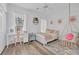Cozy bedroom with a ceiling fan, eclectic decor, and a comfortable hanging chair at 1203 Crooked Oak Dr., Pawleys Island, SC 29585