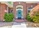 Close-up of a charming brick home's front door with arched details at 1203 Crooked Oak Dr., Pawleys Island, SC 29585